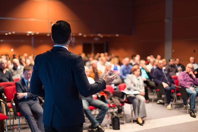 Man Presenting in Front of Crowd